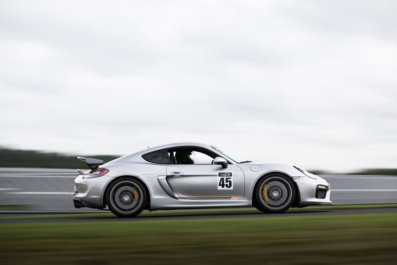 Porsche Cayman GT4 panning shot at speed on track