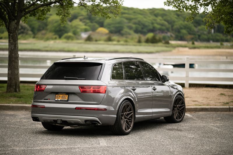 Audi Q7 on aftermarket wheels by the harbor