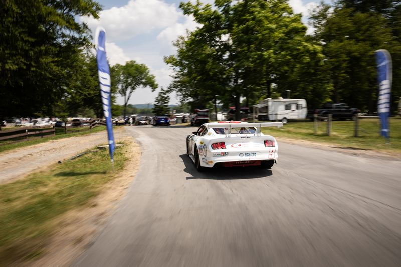 Race car heading out down the paddock lane