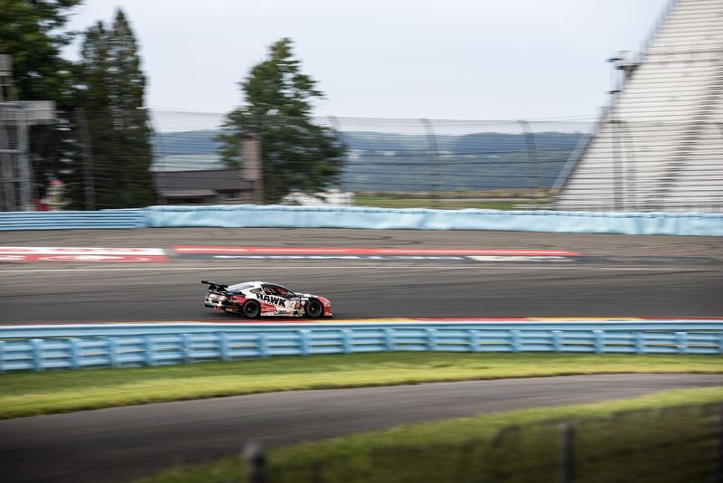 GT race car sweeping through the esses at Watkins Glen