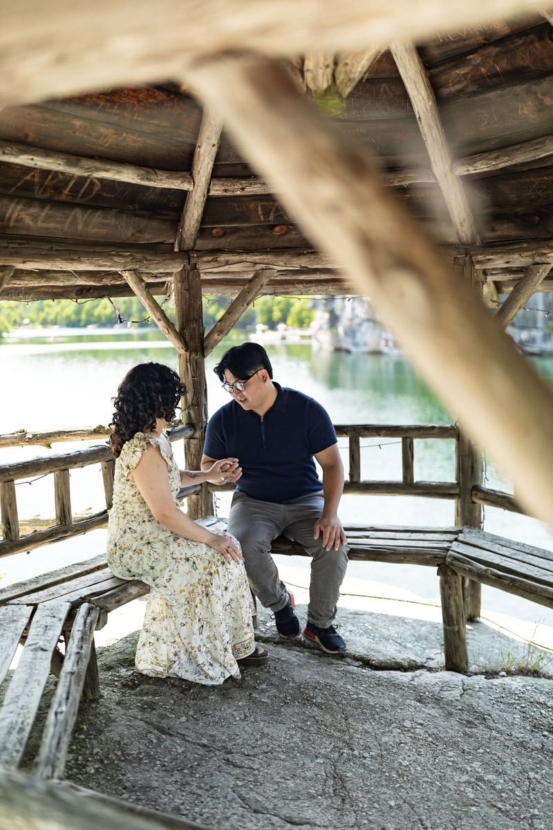 Couple seated in a lakeside gazebo