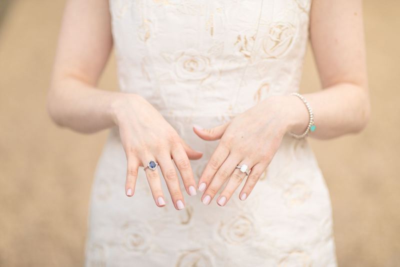 Detail of engagement rings against a lace dress