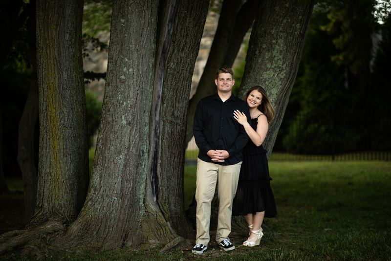 Couple posed beneath a towering old-growth tree