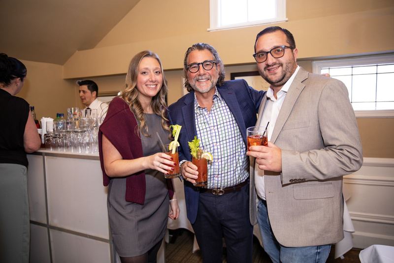 Guests raising bloody marys at a daytime reception