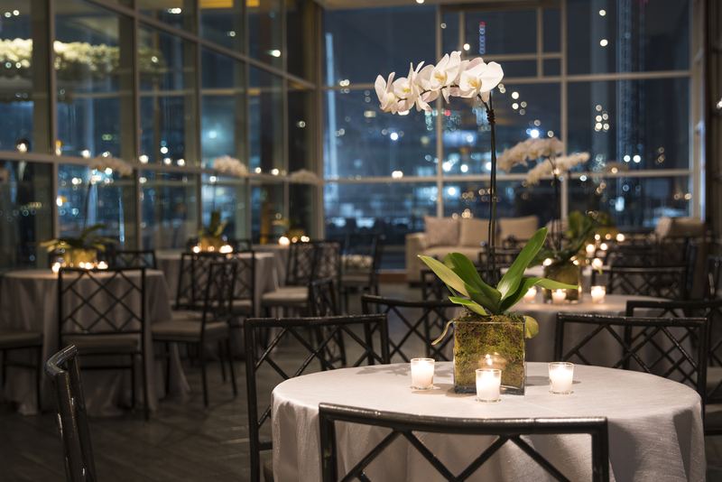 Orchid centerpiece table setting at an evening reception