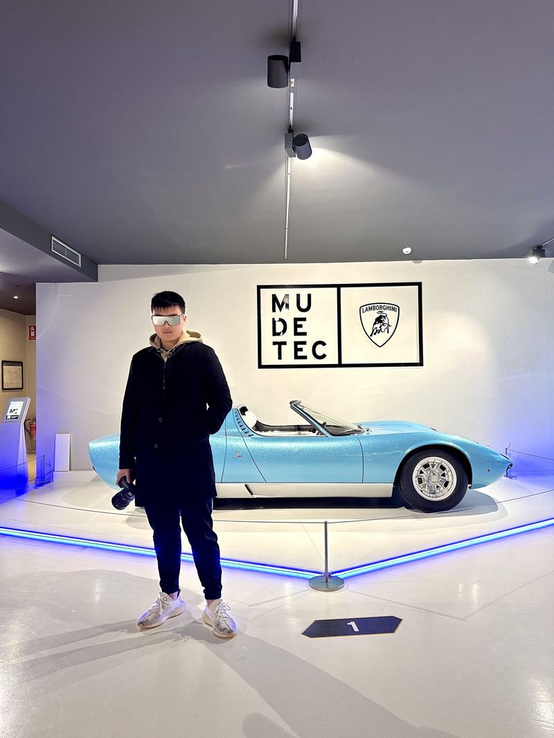 Sean, camera in hand, at the Lamborghini museum in front of a Miura Roadster